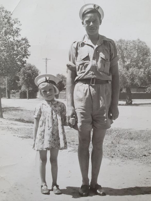 Black and white photo of Naval officer Jack Bartlett alongside his little sister, wearing a sailor's cap. Dec 1942. 