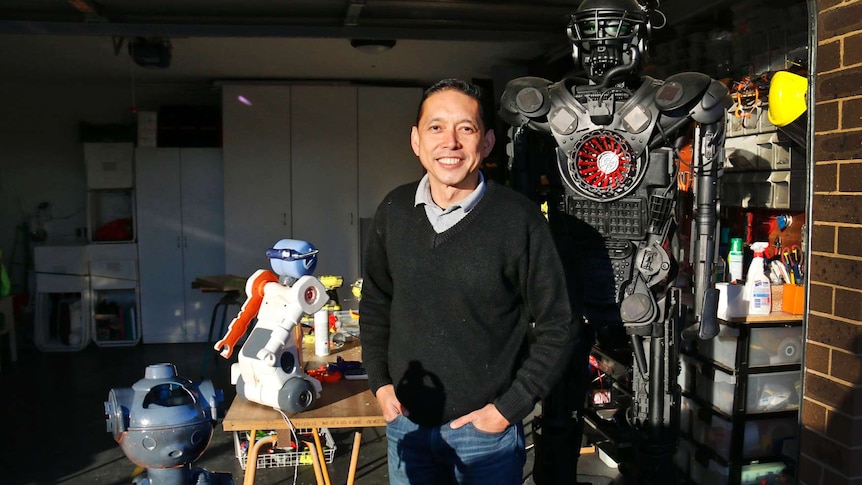 Man surrounded by robots.