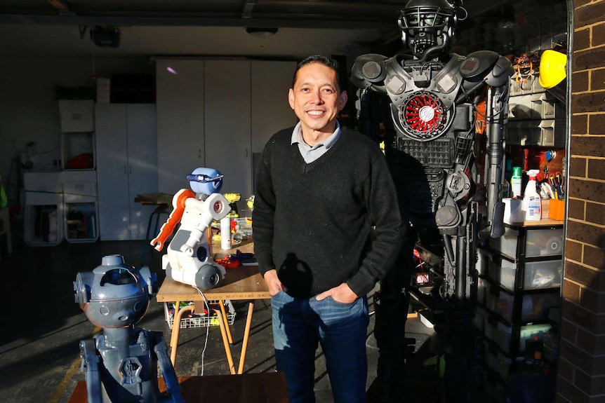 Man surrounded by robots.