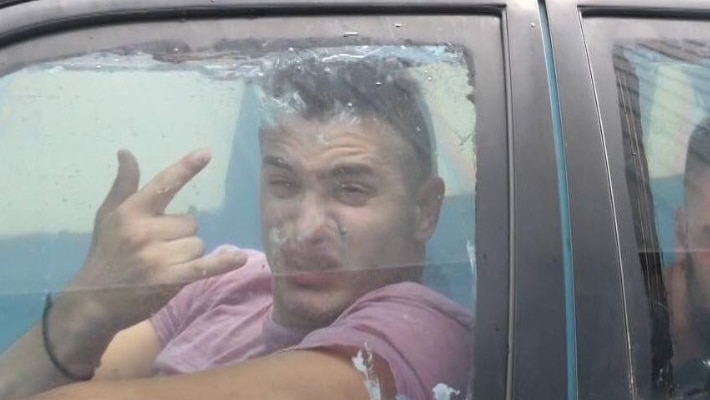 A man in the front seat of a car filled with water.