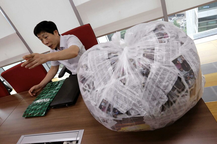 Park Sang Hak sits next to a bag of anti-North Korea leaflets during an interview in Seoul.