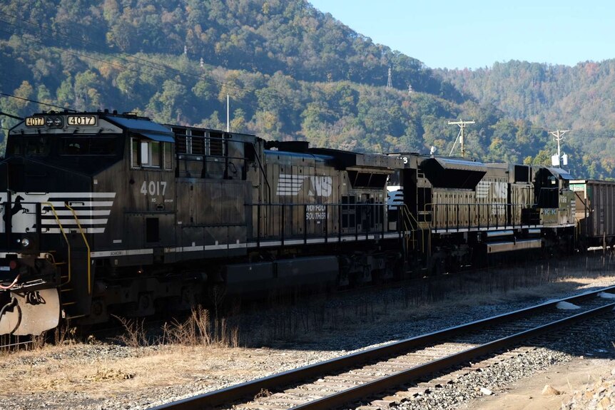 A train packed with coal runs through the West Virginia countryside.