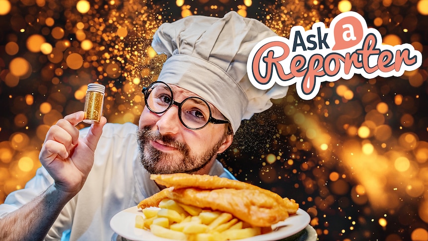 Joe dressed as a chef holds a small container of glitter above some battered fish and chips.
