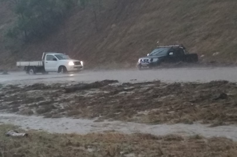Cars in flood water just north of Macs Reef Road on the Federal Highway.