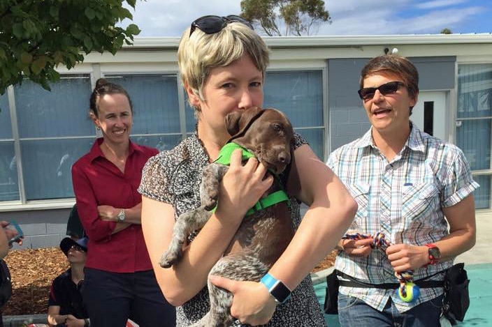 Vanessa Goodwin holds a puppy