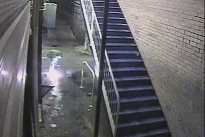 CCTV footage showing a man lighting a trail of accelerant outside the cafe's back entrance.