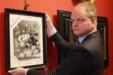 Director of the Uffizi Gallery Eike Schmidt stands with a copy of the painting Vase of Flowers