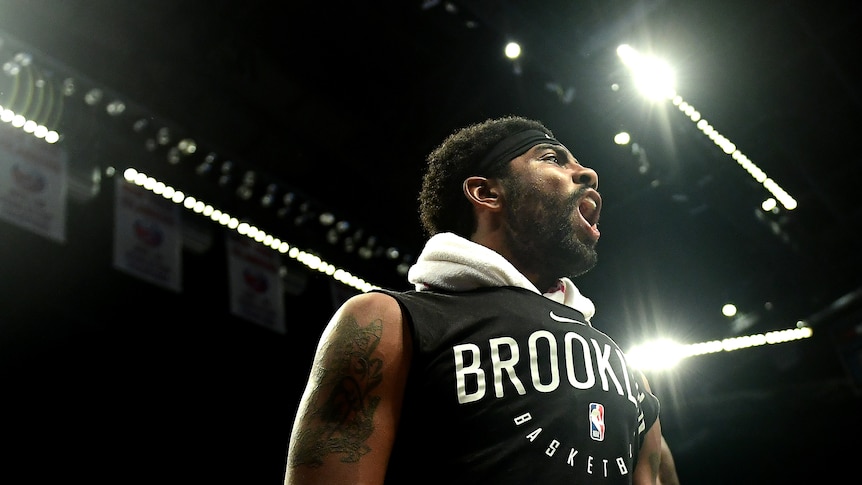 Basketball player standing on the floor yelling during a match