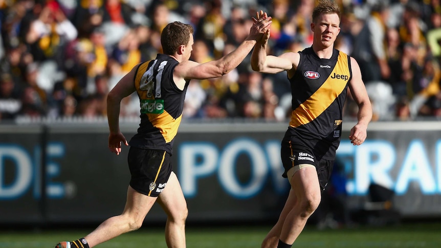 Nathan Foley and Jack Riewoldt celebrate a goal for Richmond against Brisbane at the MCG.