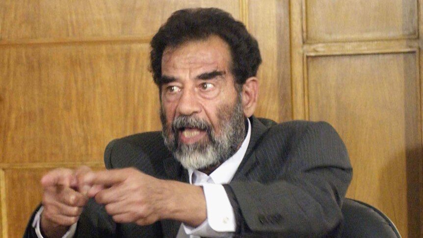 Saddam Hussein sits in court in Baghdad