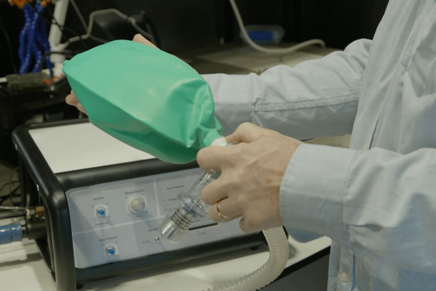 A man holds a ventilator device
