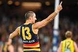 Taylor Walker points to the crowd after kicking a goal for the Adelaide Crows against Richmond Tigers.