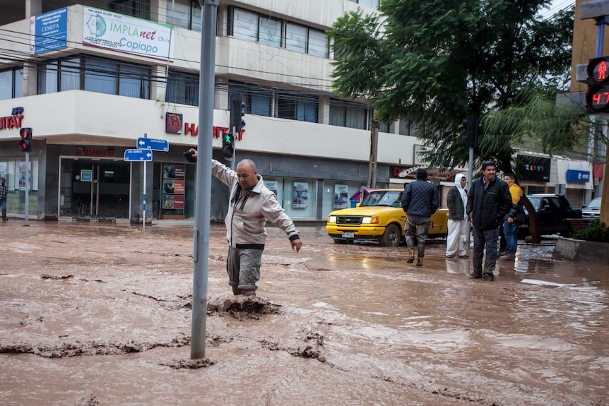 A man wades through the flooded streets of Copiapo in northern Chile