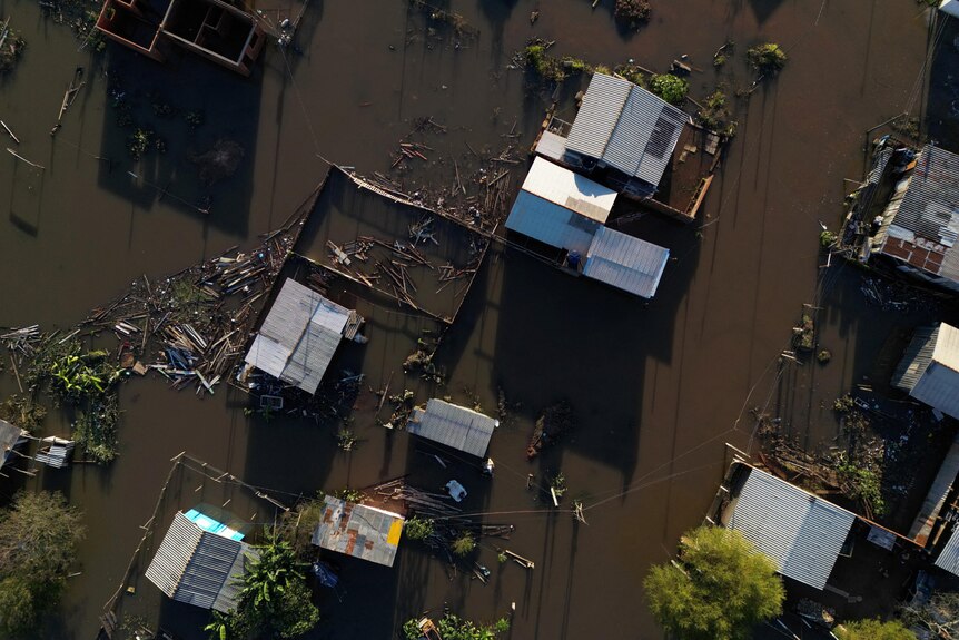 An aerial view shows damage and flooding.