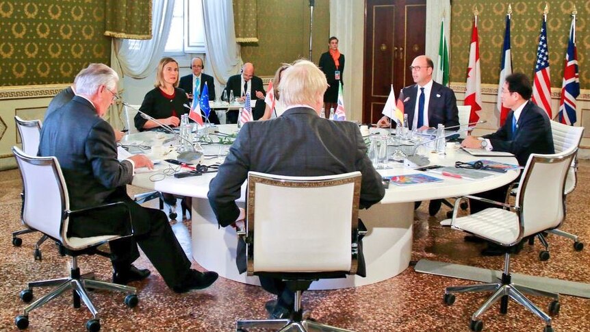 Foreign ministers from G7 countries sit around a table.