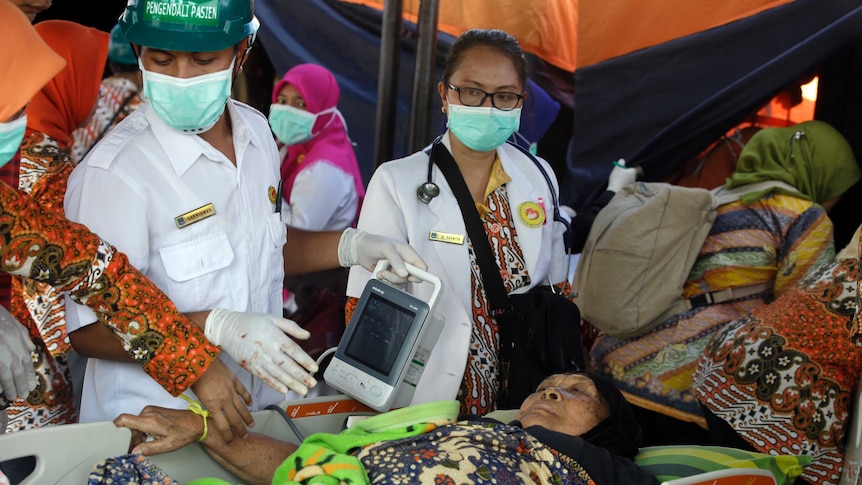 A woman injured in an earthquake is treated in Lombok