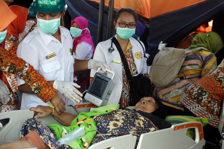 A woman injured in an earthquake is treated in Lombok