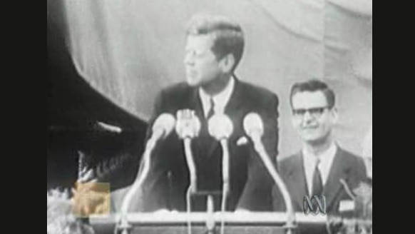 John F Kennedy at microphone
