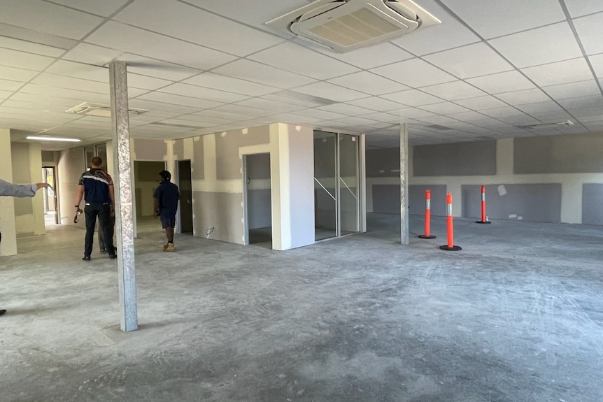 People inspect a newly rendered office space on Palm Island.