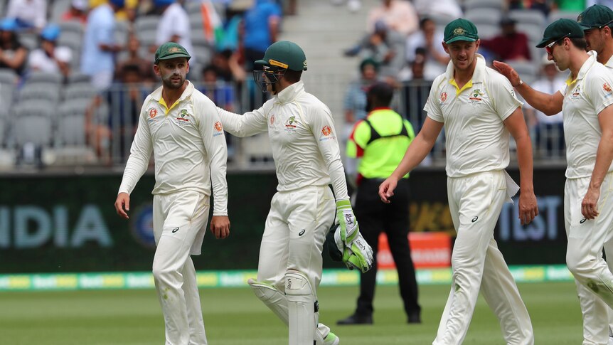 Tim Paine congratulates Nathan Lyon after the bowler's five-wicket haul
