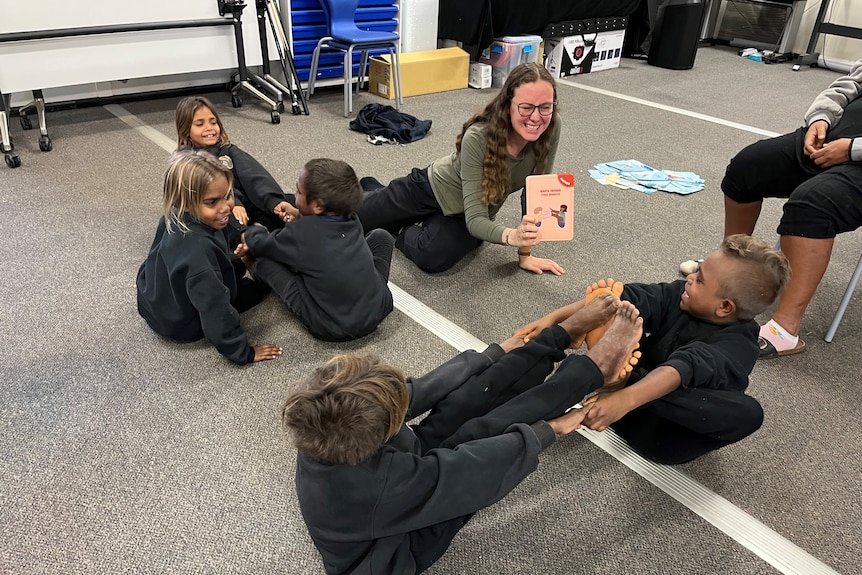 Ngaanyatjarra Lands School Warakurna Campus principal Shelly Maes helps students doing yoga