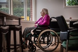 Dorothy Major looks out the window at her aged care home. She sits in a wheelchair.