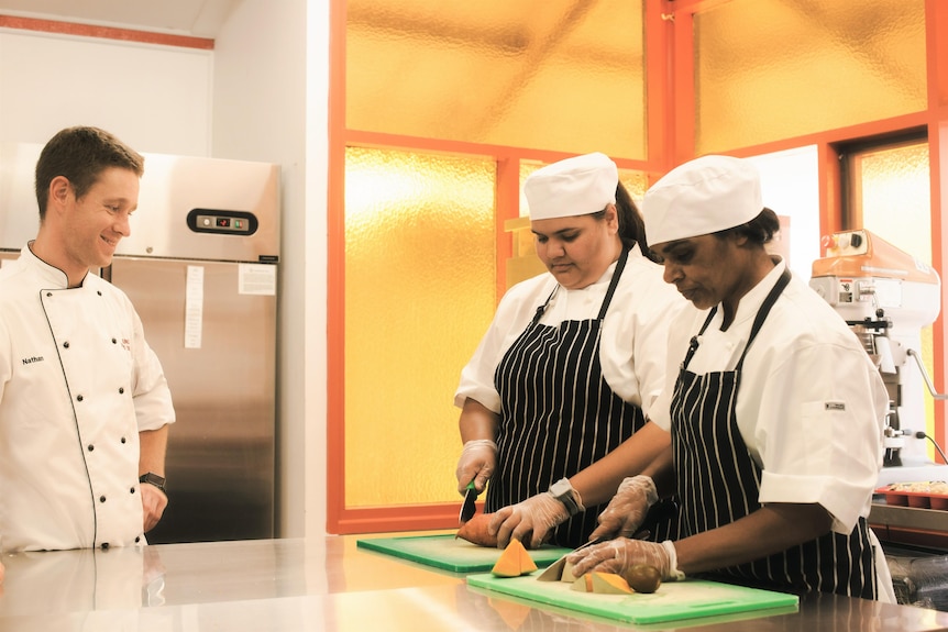 Bungala Food Service manager Nathan Freeman teaching trainees how to cook. 