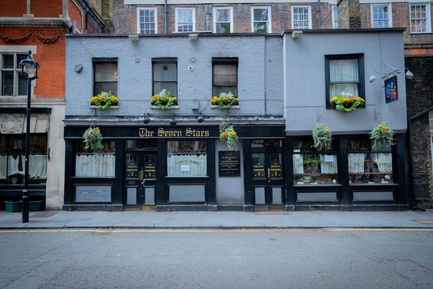 The exterior of the Seven Stars pub with hanging floral baskets in the windows