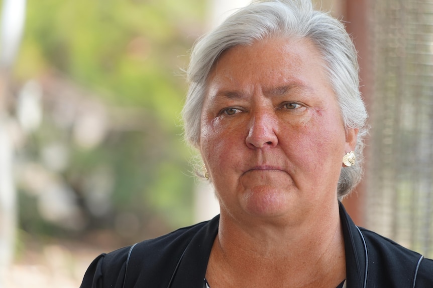 NT Senator Sam McMahon speaking to the media at a press conference, looking serious. 