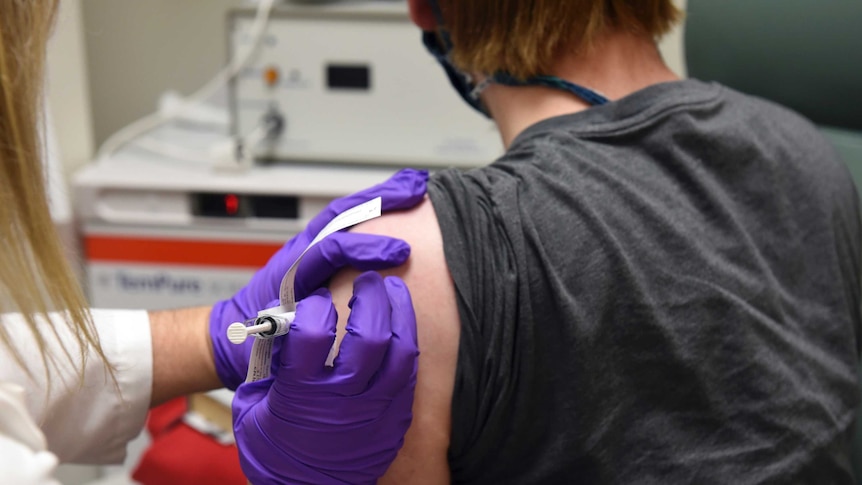 A patient enrolled in Pfizer's COVID-19 coronavirus vaccine clinical trial receives an injection