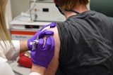 A patient enrolled in Pfizer's COVID-19 coronavirus vaccine clinical trial receives an injection