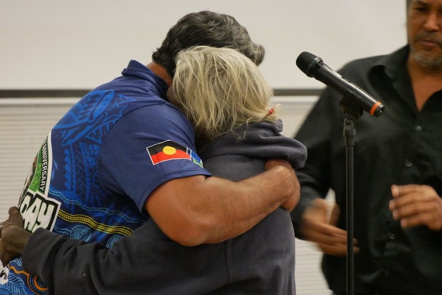 A man hugs his mother.