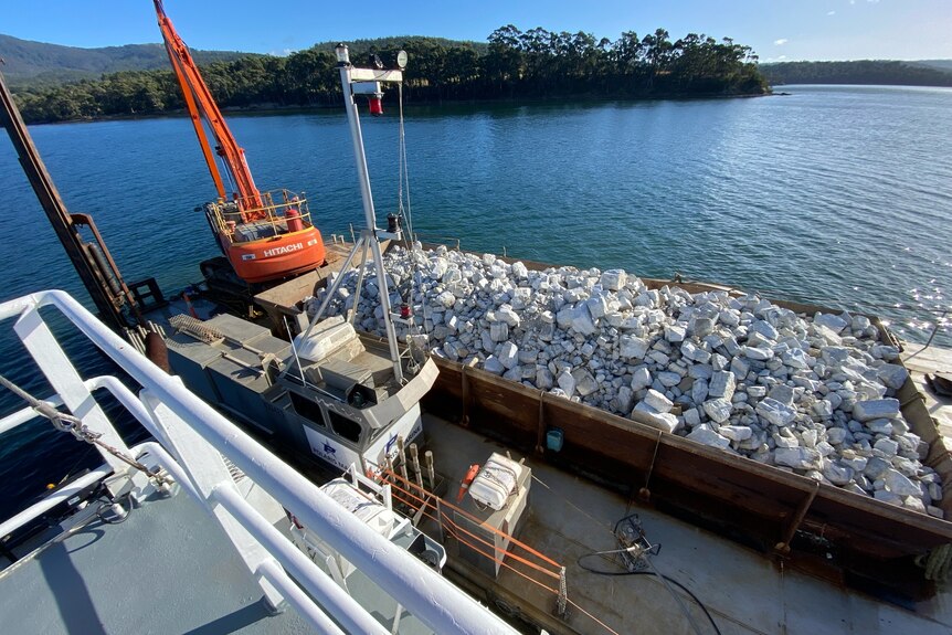 the rocks on the barge will be tipped onto the reef site.
