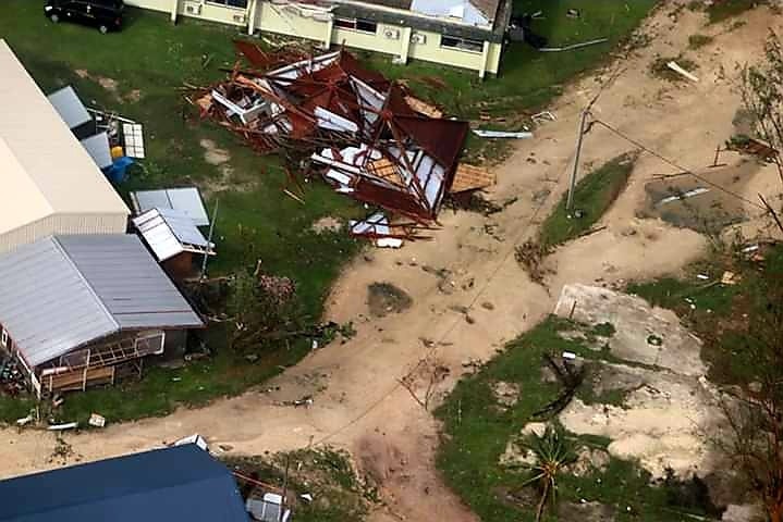 A flattened house can be seen from above in an aerial photo.