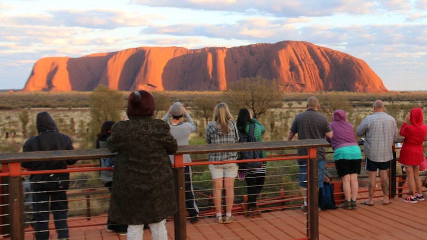 Tourists photographing Uluru.