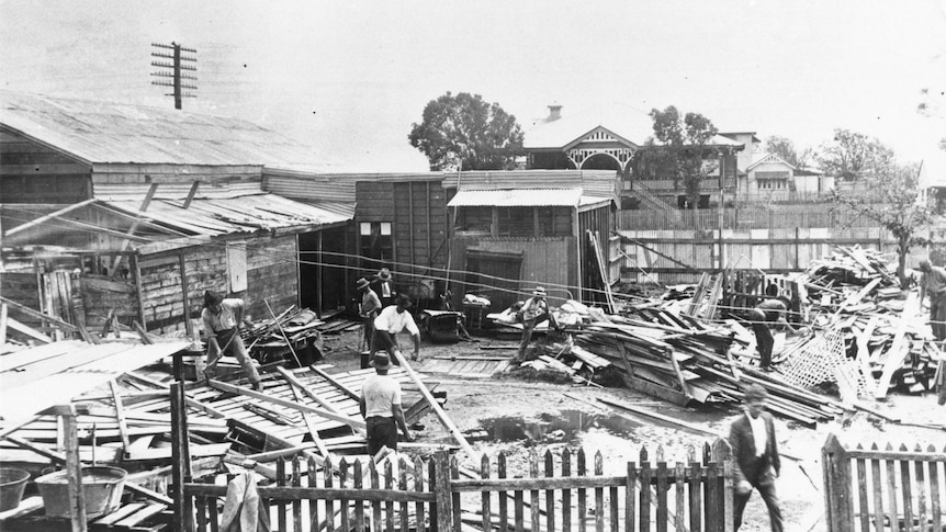 A group of helpers start the recovery process after the 1918 cyclone.