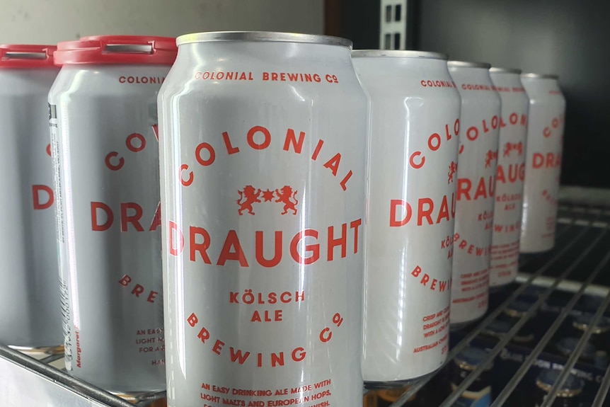 A 6 pack of colonial brewing company beers on a shelf