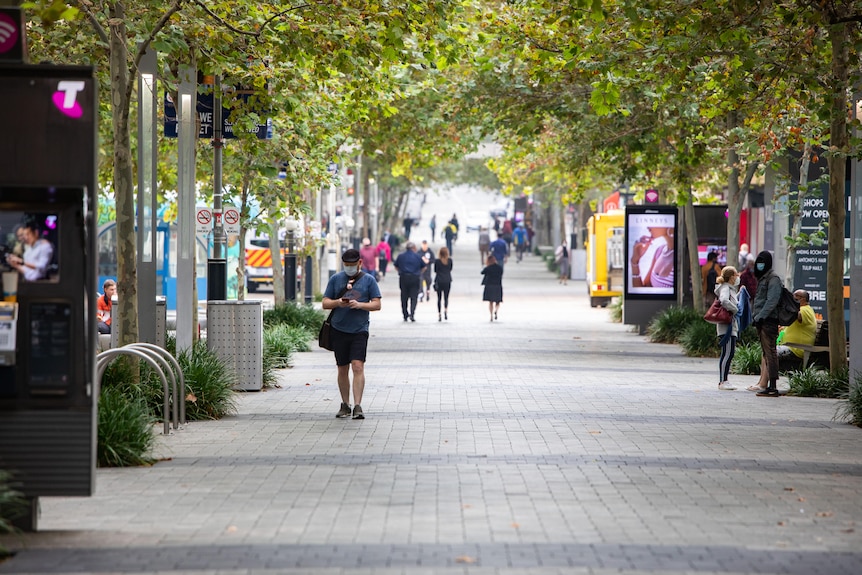 A wide shot of Hay Street in Perth with a few pedestrians walking and standing around.