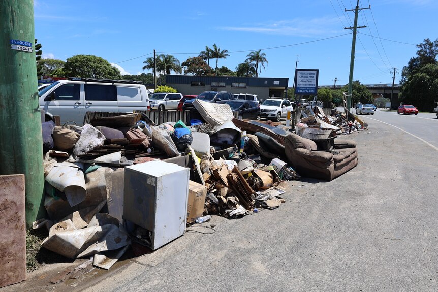 wet and damaged furniture and household goods on the street