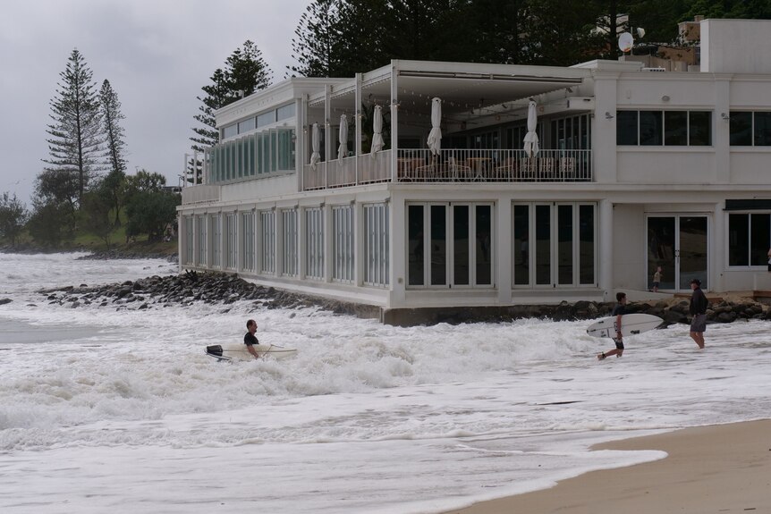 Waves crash next to restaurant at Burleigh Heads as ex-Tropical Cyclone Seth sits offshore 