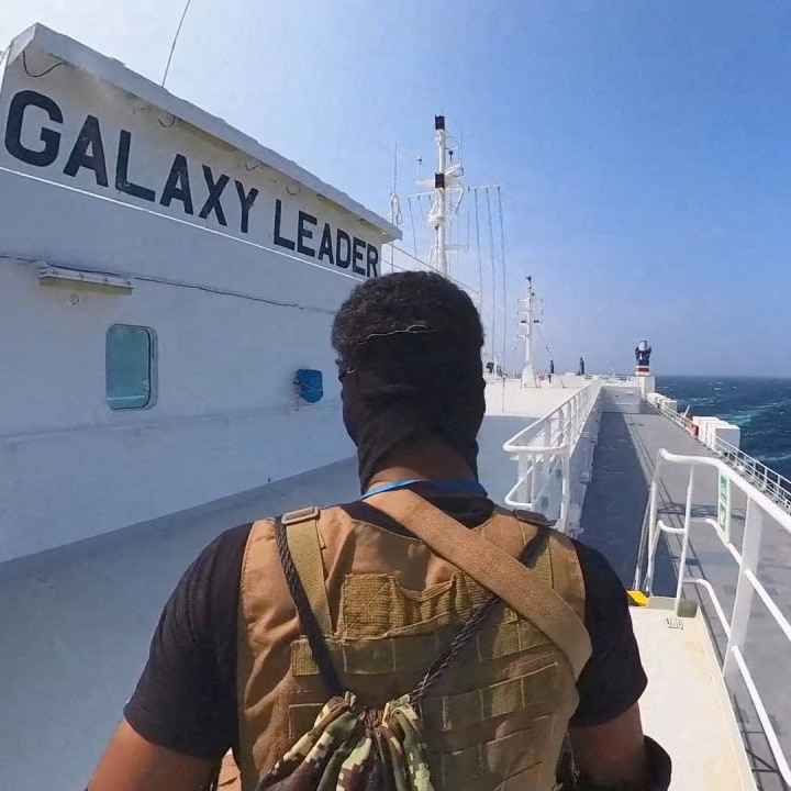 the back of a man with a mask on on  acargo ship
