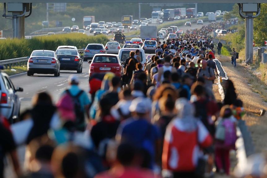 Asylum seekers march along the highway towards the border with Austria, out of Budapest, Hungary.