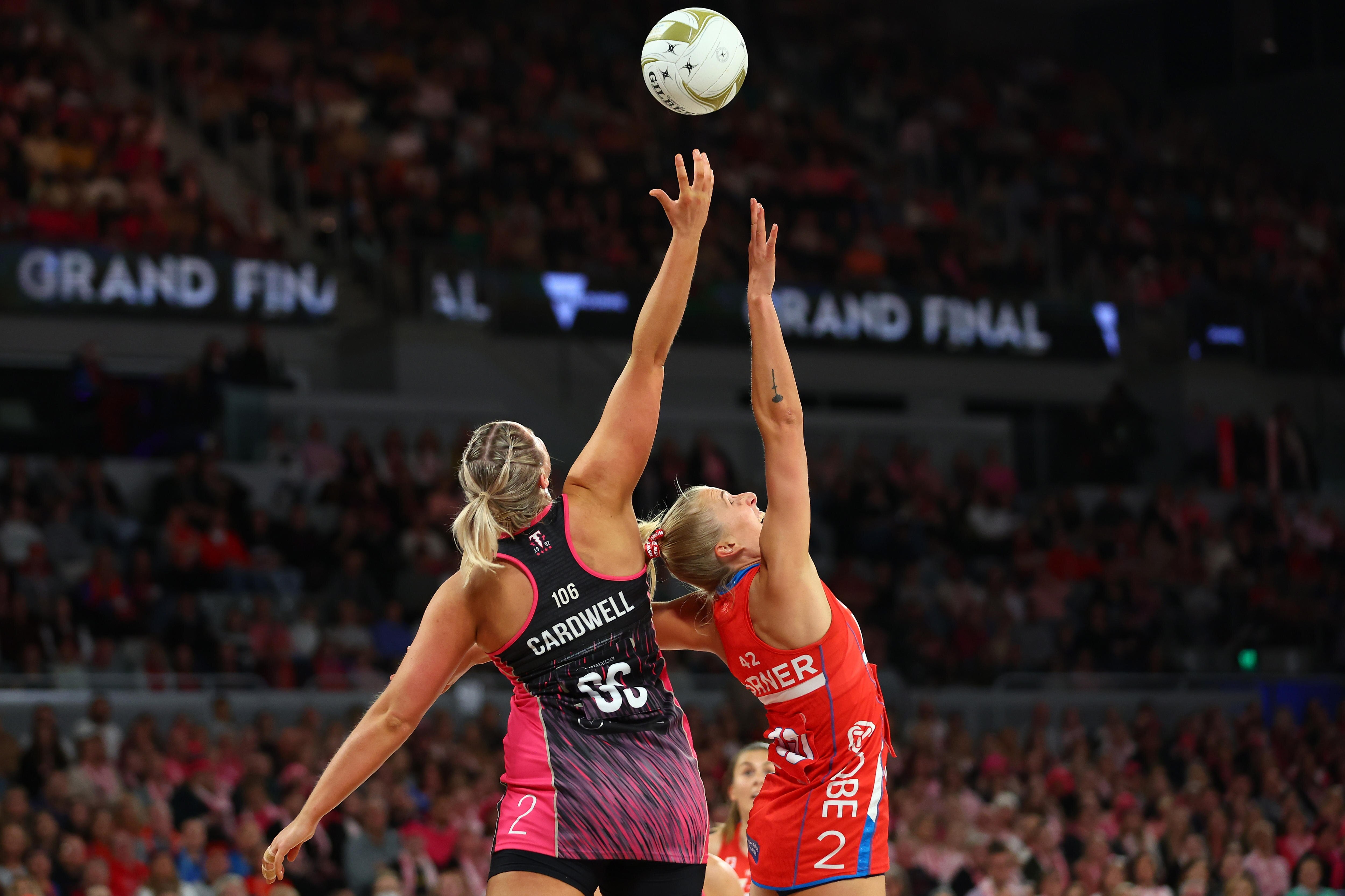 Netball players contest the ball