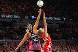 Netball players contest the ball