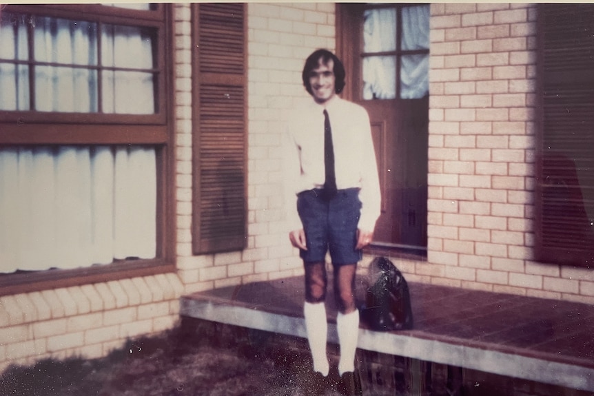 A man in long socks and professional attire.