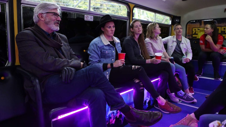 Shaun Micallef with people on a pub crawl for documentary On The Sauce about Australia's relationship with alcohol