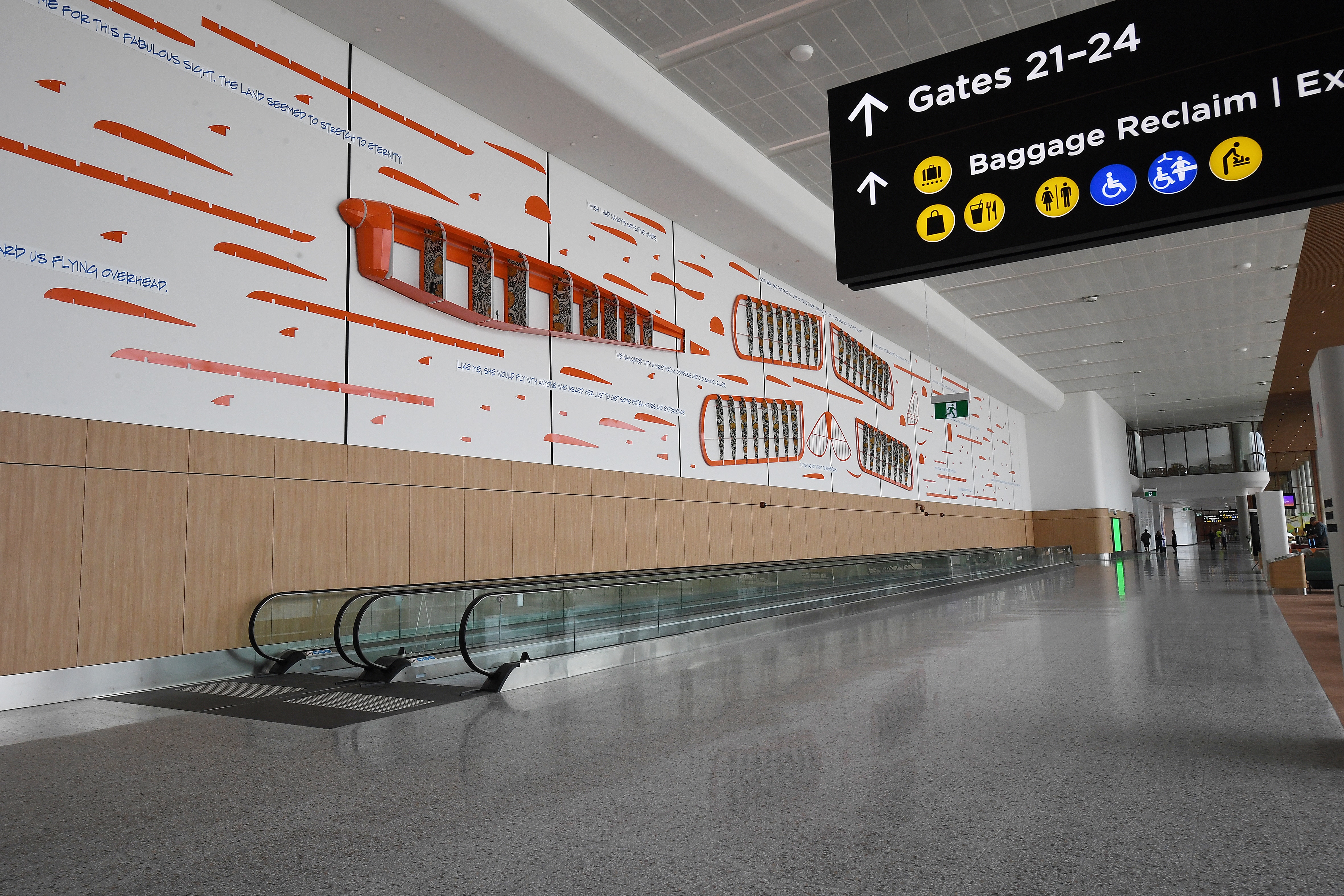 A huge artwork depicting a disassembled biplane on the wall of an airport terminal.