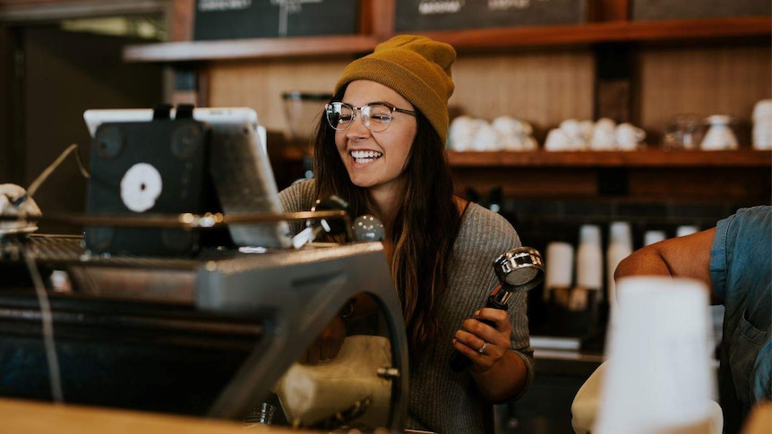 Woman working the cash register at a cafe