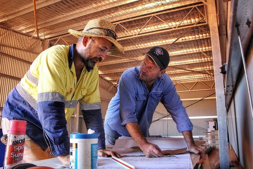 Kimberley pastoralist Jack Burton discusses the construction of the abattoir with contractor Adam Kerr.