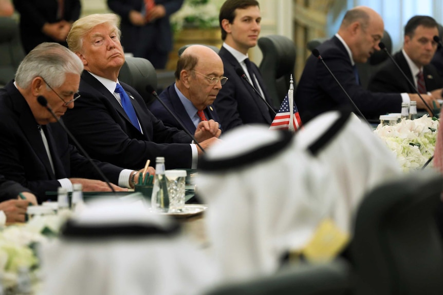 Donald trump and rex tillerson sit at a table across from the saudi delegation in riyadh